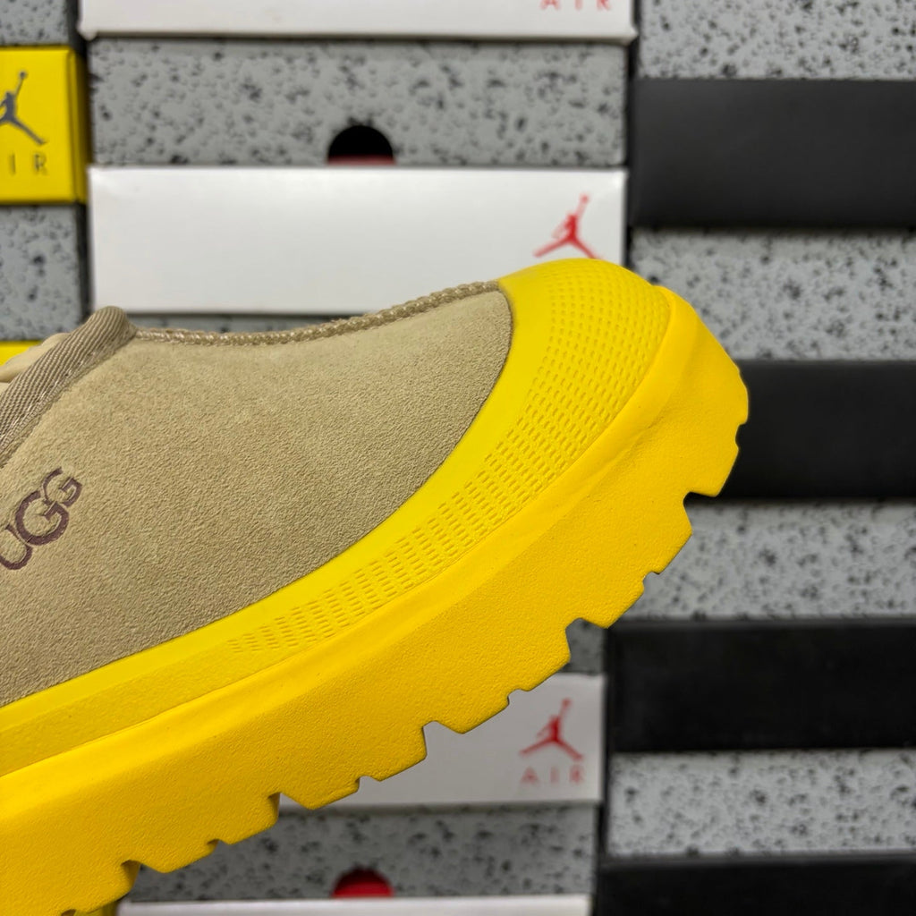UGG Neumeel Deco Slip-On – Suede Moccasin Sneaker with Yellow Lug Sole & Carabiner Collar in Sand
